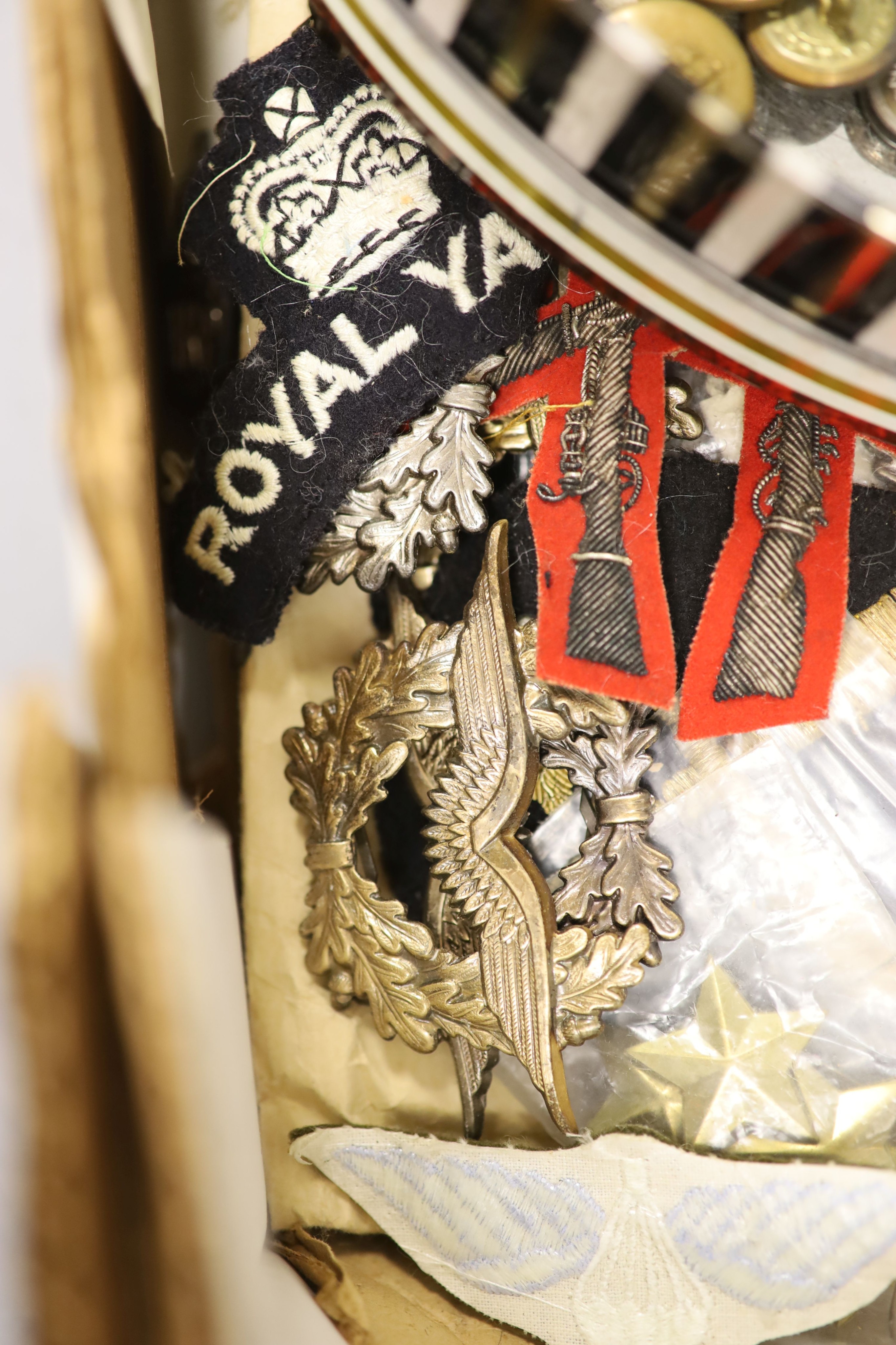 A group of British military cap badges and buttons, various commemorative medals and Pakistan General Service Medals